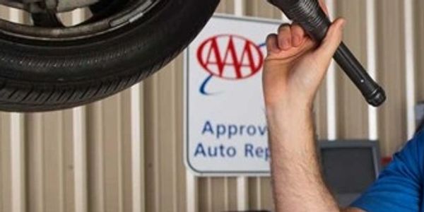 Man shining flashlight on vehicle